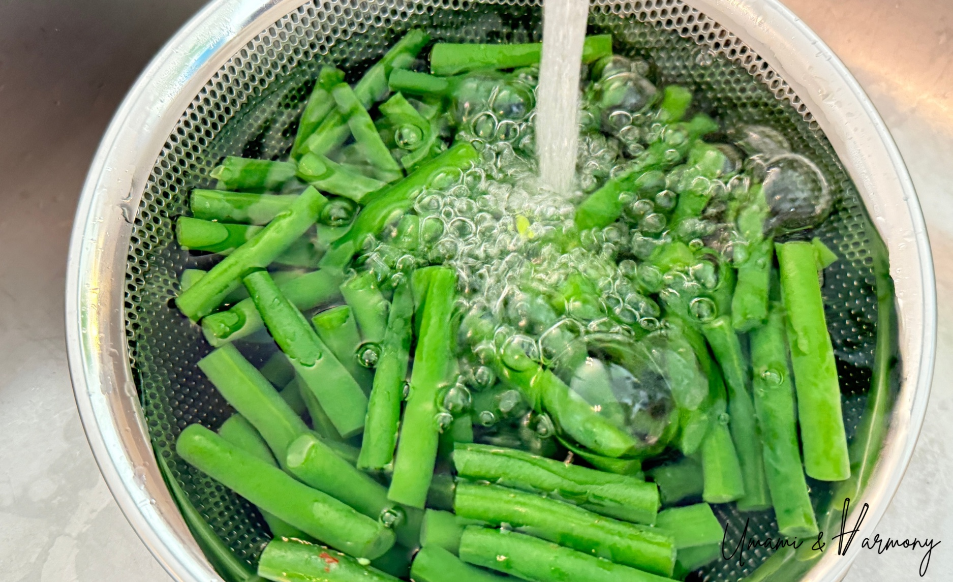 Cool the green beans under running water to stop the cooking process.