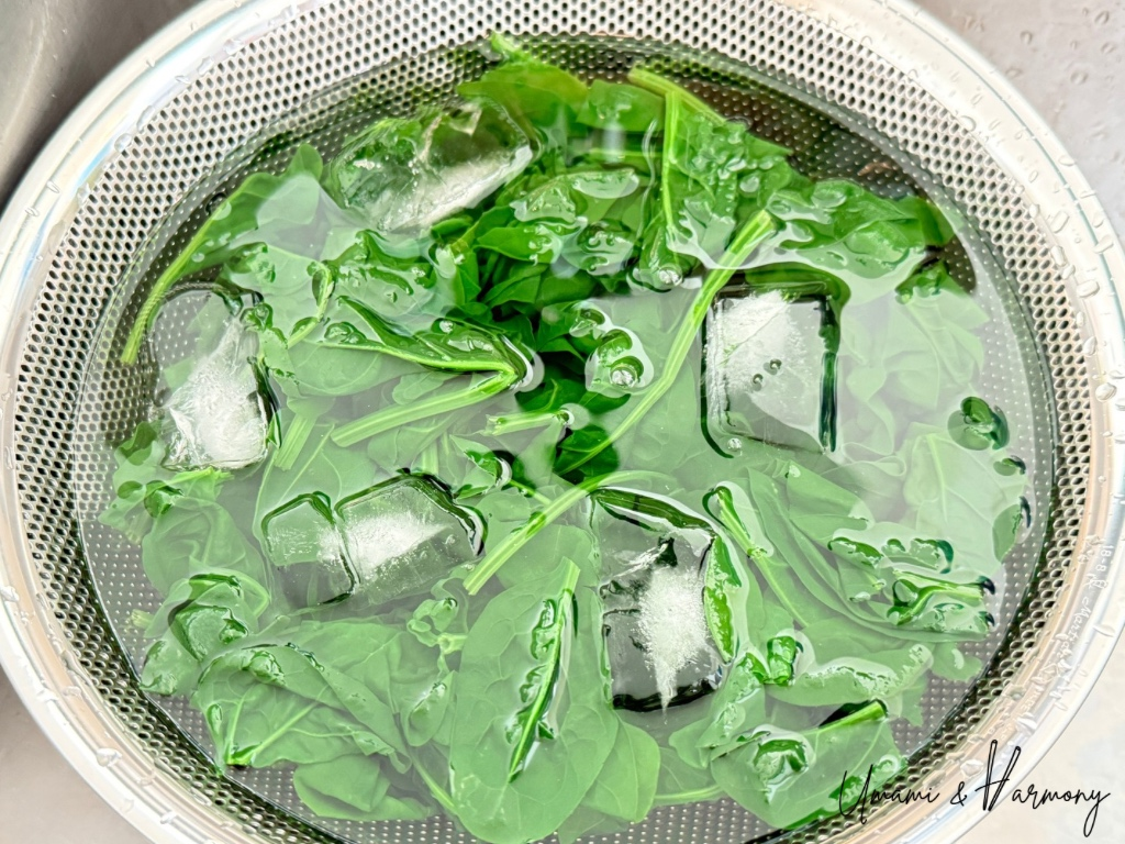 Blanched spinach cooled in an ice bath