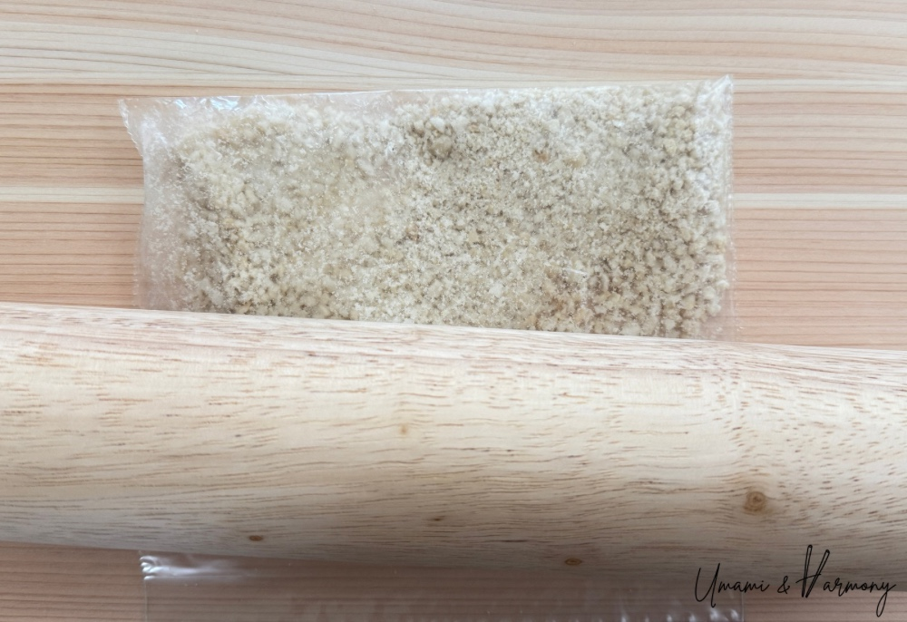 Completely crushed peanuts inside a plastic zip bag.