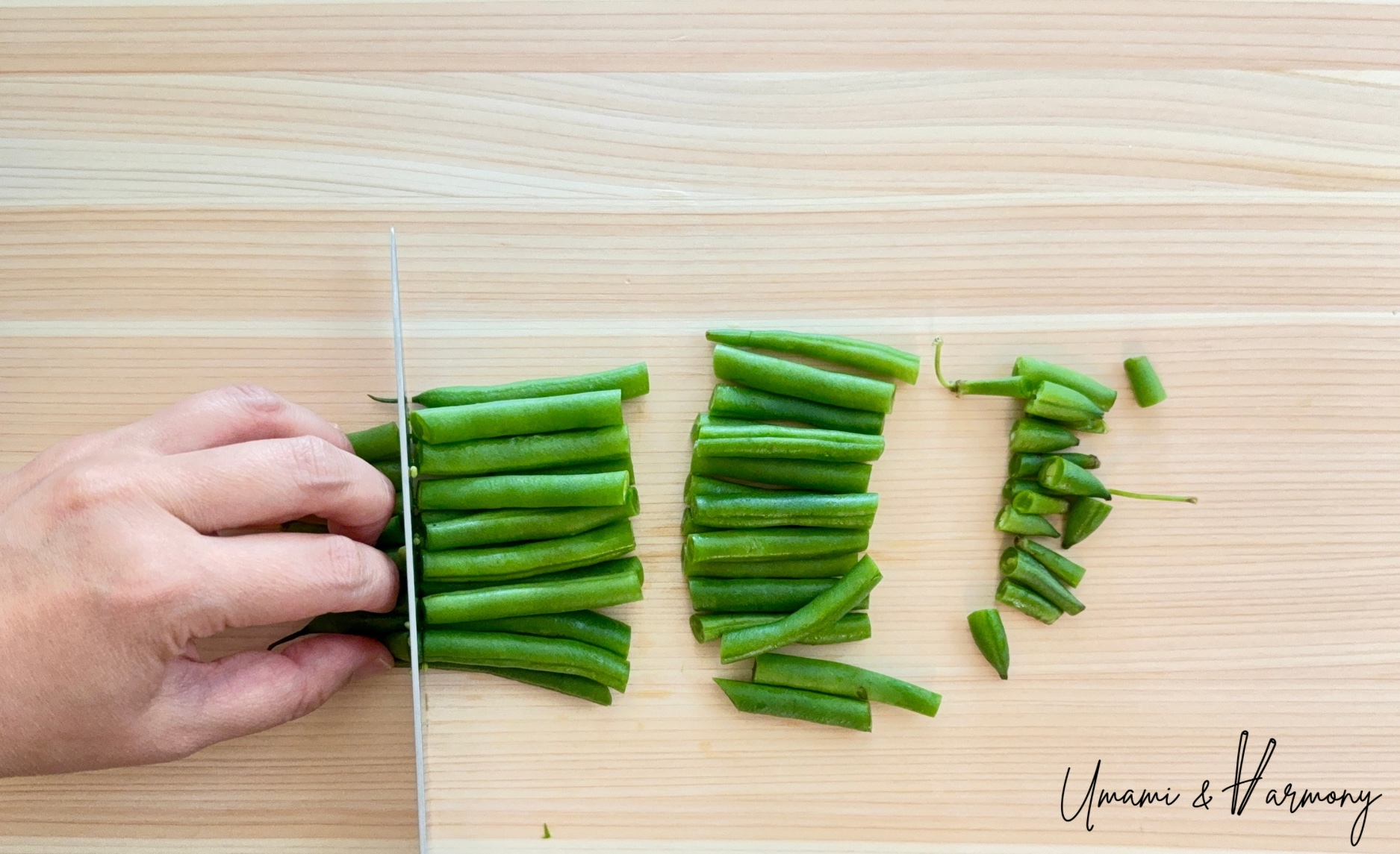 Green beans being cut into 1-inch pieces.
