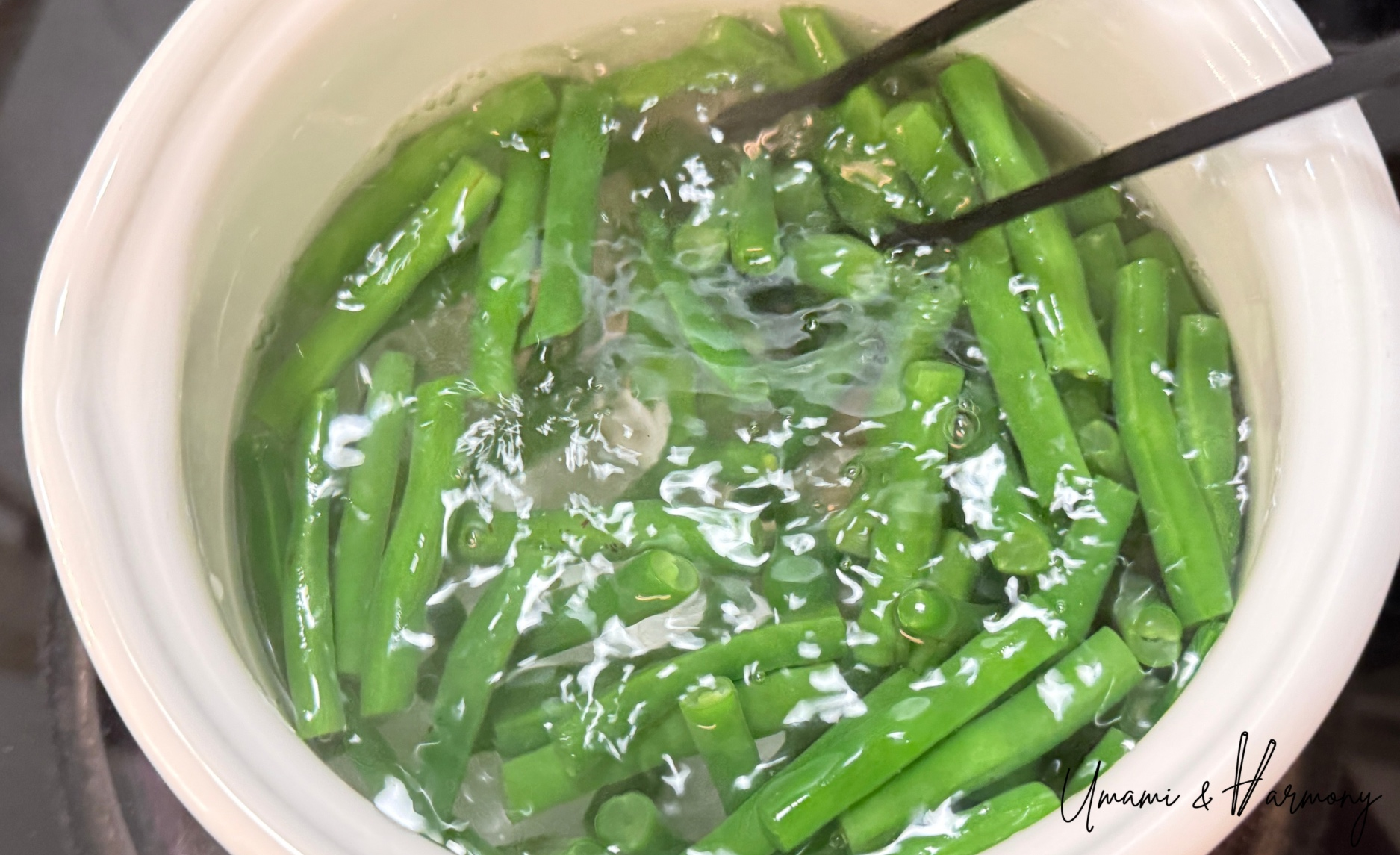 Cut green beans boiling in a pot.