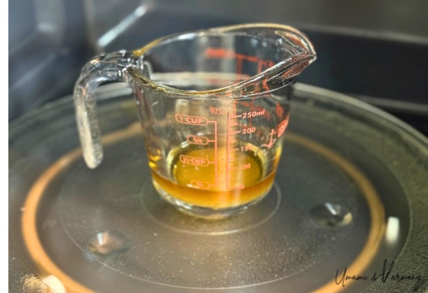 Glass cup with dressing inside a microwave