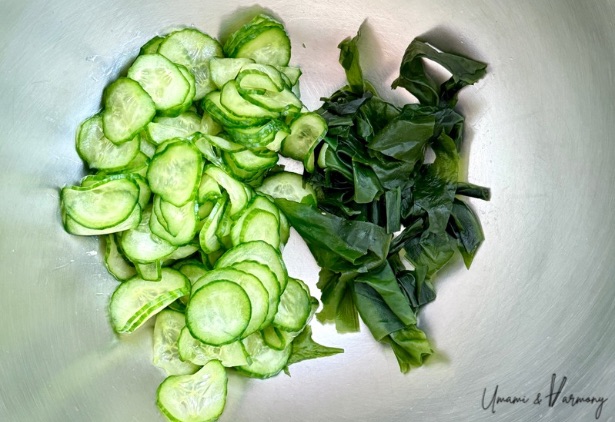 Bowl with sliced cucumbers and rehydrated wakame before mixing