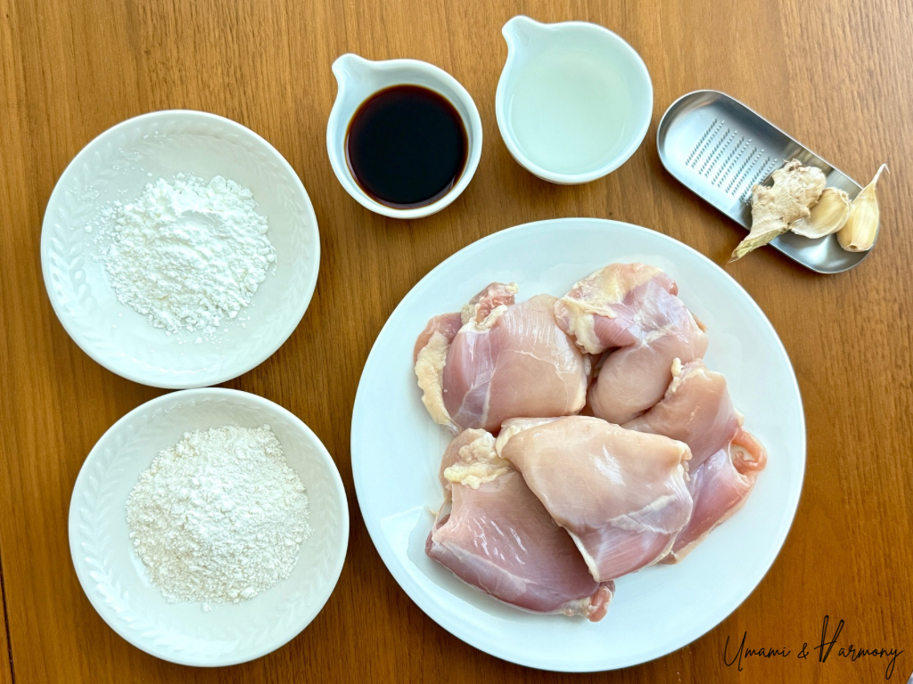 Karaage chicken ingredients: chicken thighs, soy sauce, sake, garlic, ginger, cornstarch, and flour
