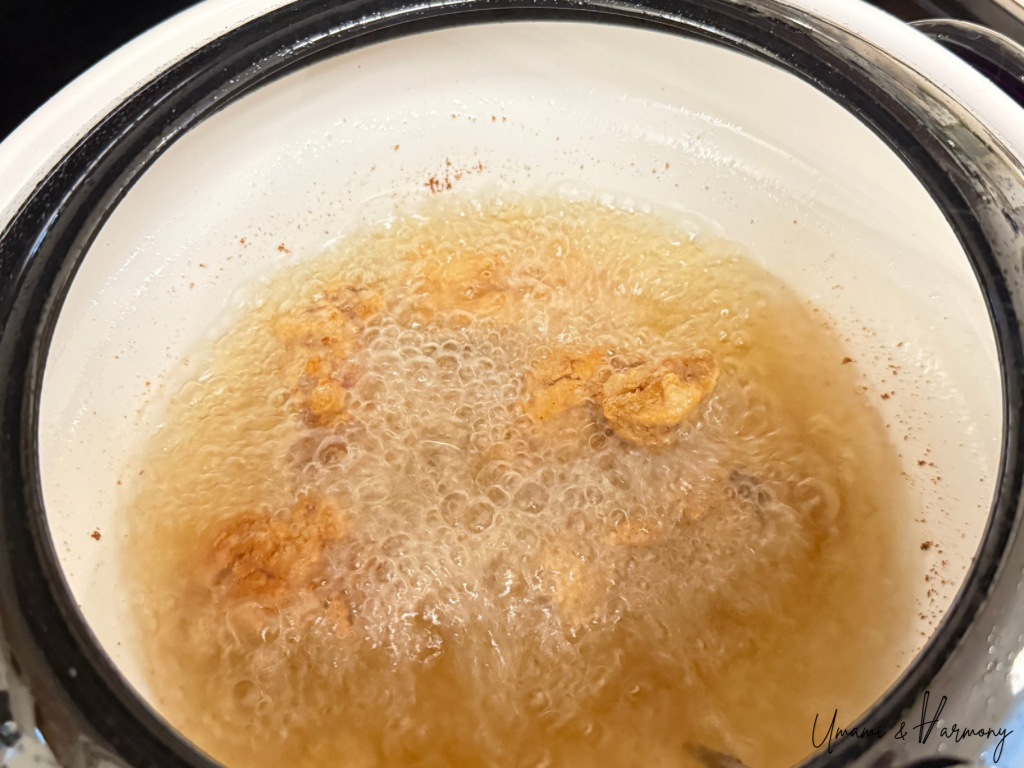 Chicken pieces frying again for the second fry in hot oil.