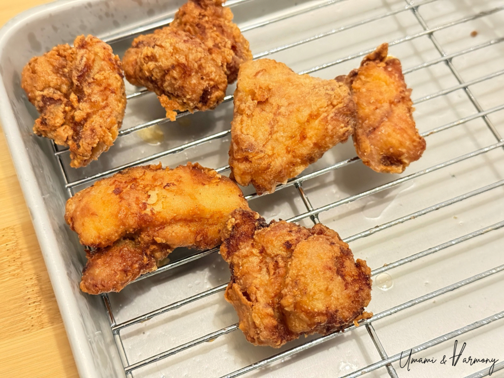 Deep golden brown karaage chicken resting on a wire rack.