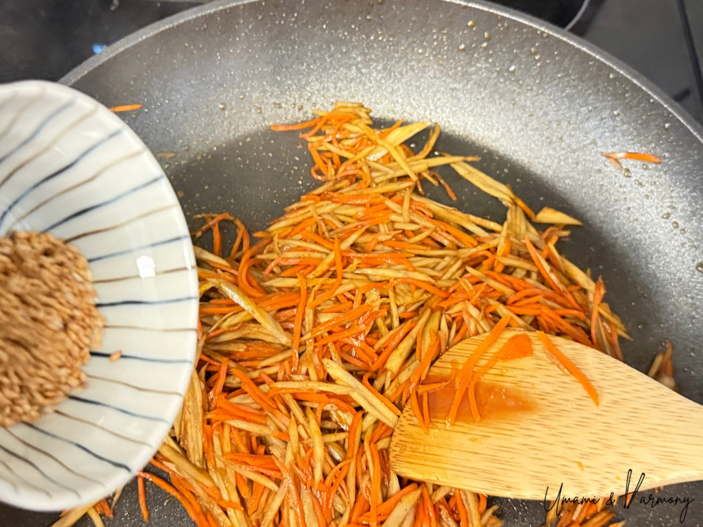 Roasted sesame seeds sprinkled into Kinpira Gobo