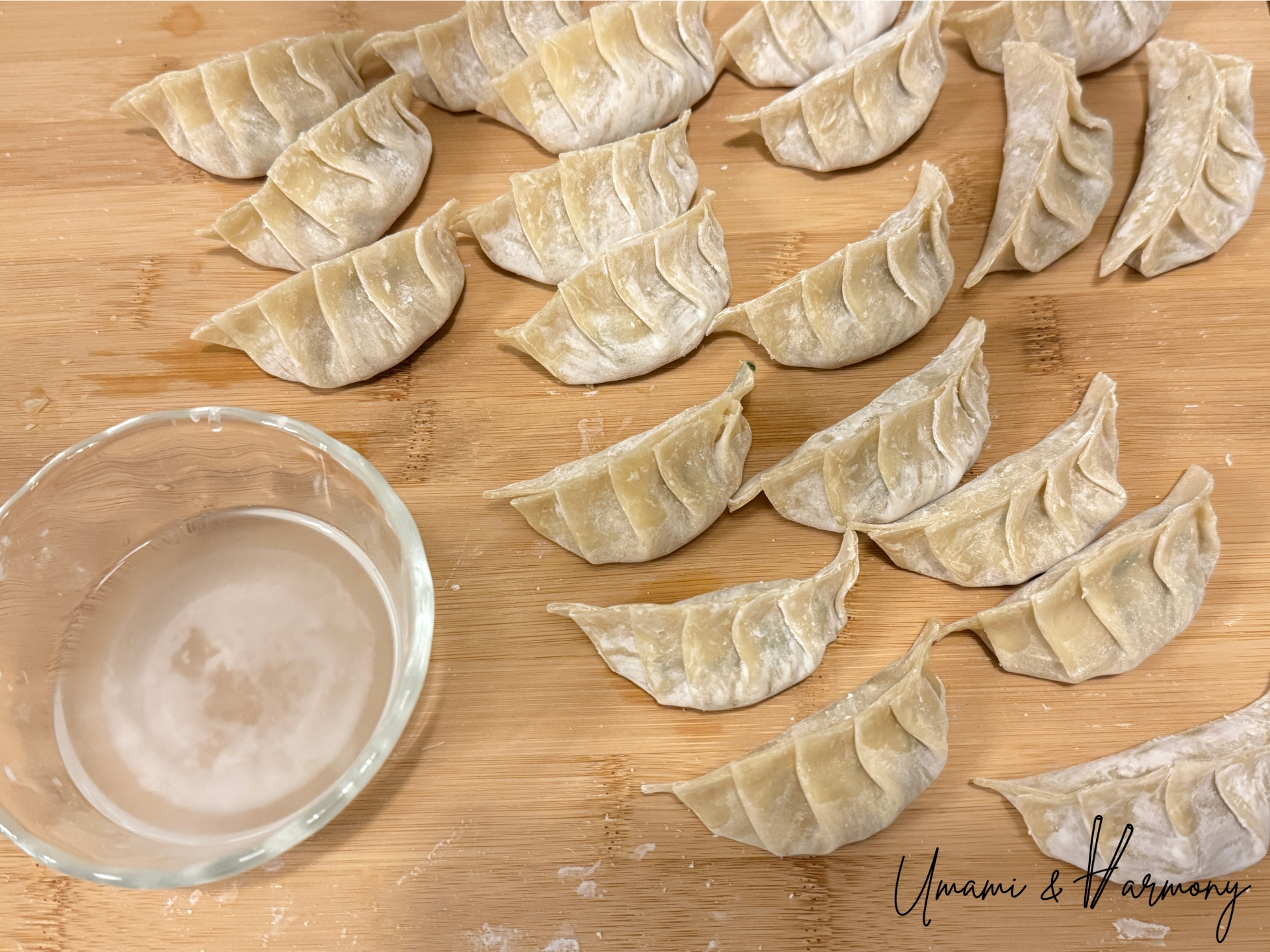 Folded gyozas on a cutting board ready to cook