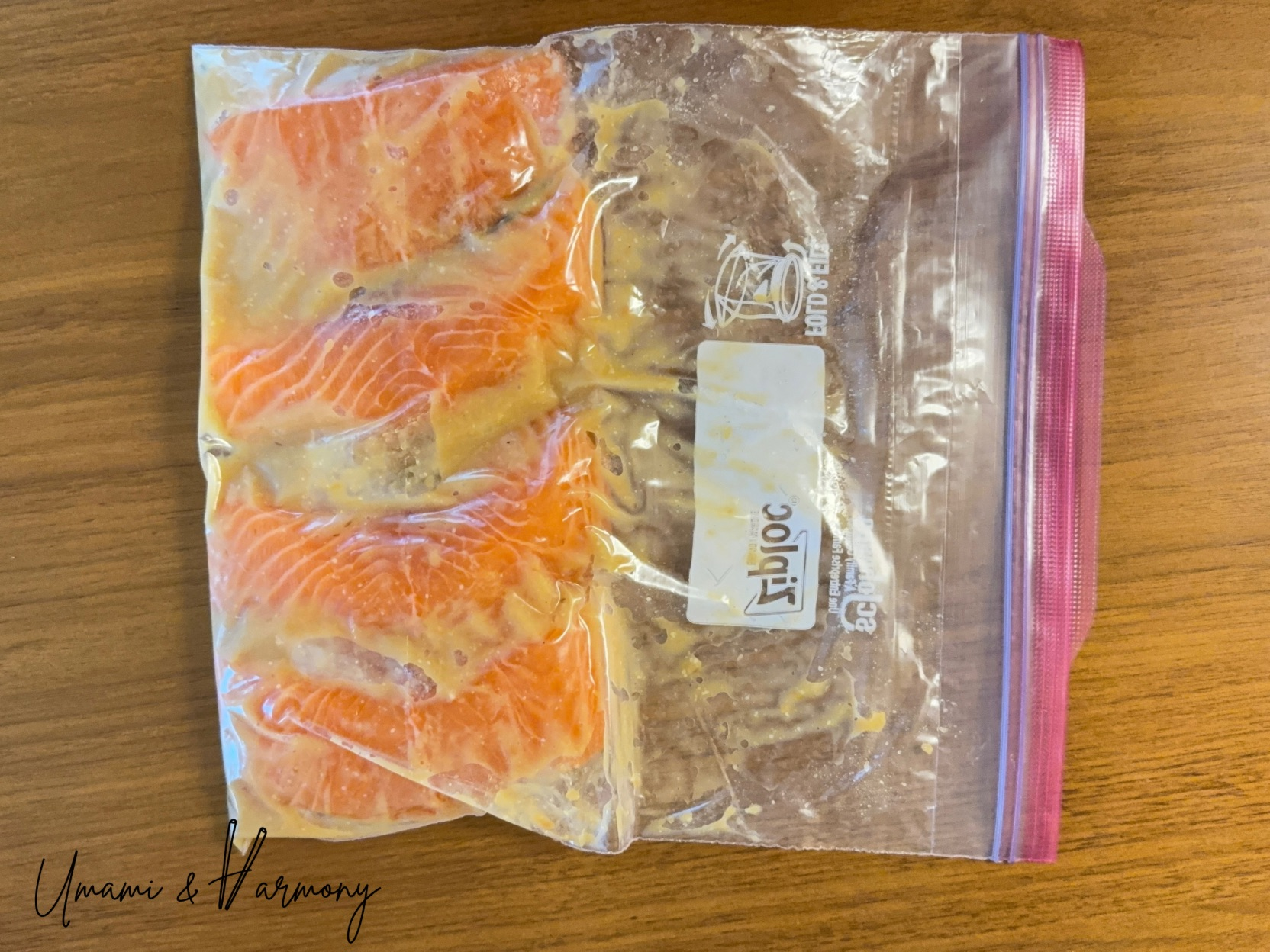 Salmon fillets placed in a zip bag with miso marinade