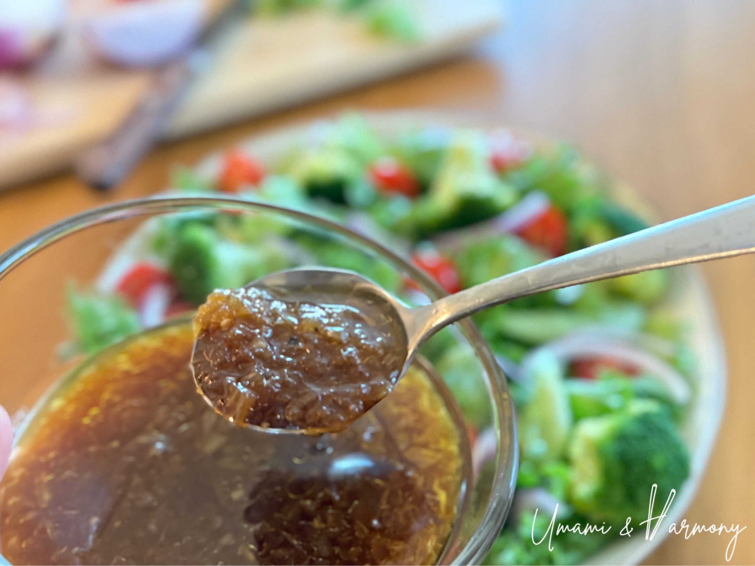 A scoop of Japanese onion dressing with fresh salad in the background