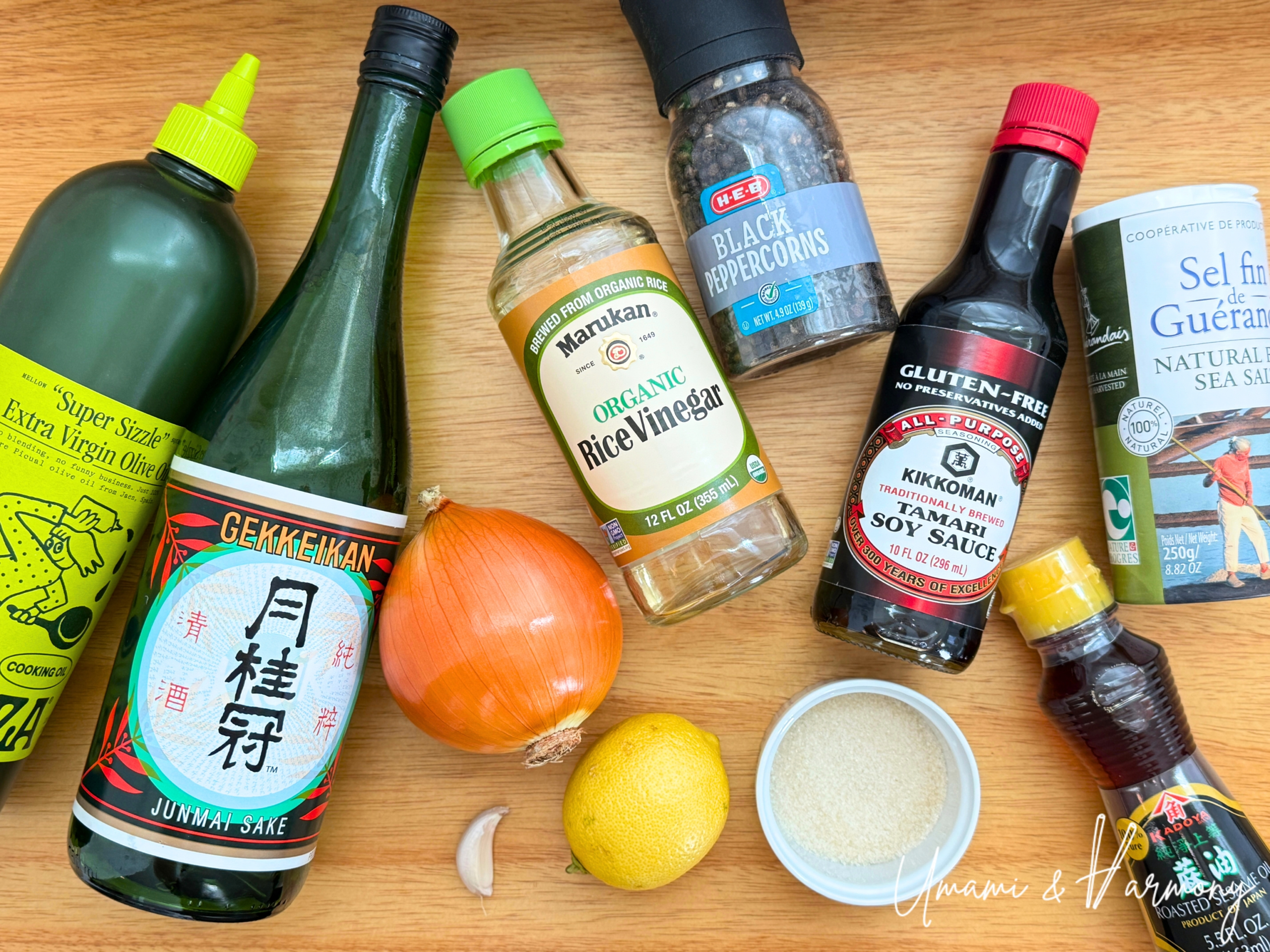 Ingredients for Japanese onion dressing: olive oil, sake, onion, lemon, garlic, sugar, rice vinegar, black pepper, tamari soy sauce, sesame oil, and sea salt