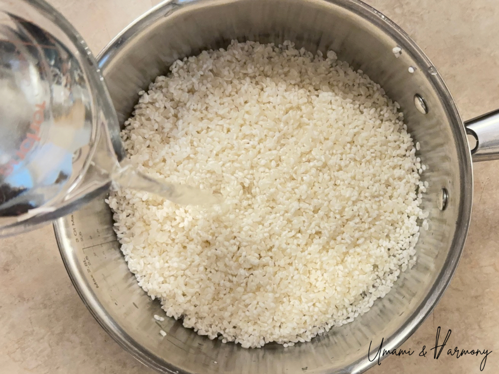 Transferring rinsed sushi rice into a cooking pot and adding water