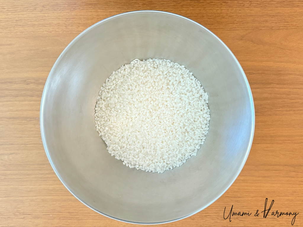 Dried sushi rice in a mixing bowl, ready for rinsing