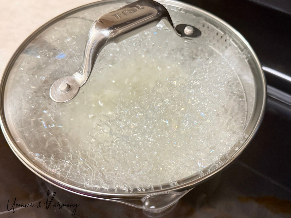 Pot of sushi rice starting to boil