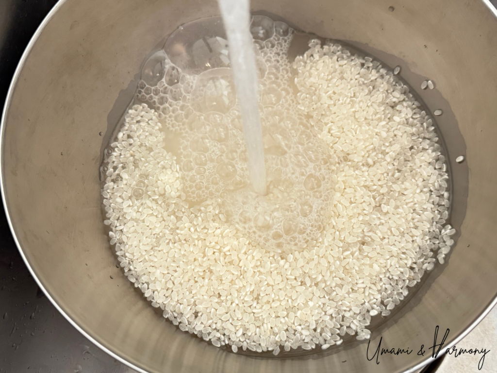 Water being poured into a bowl of sushi rice