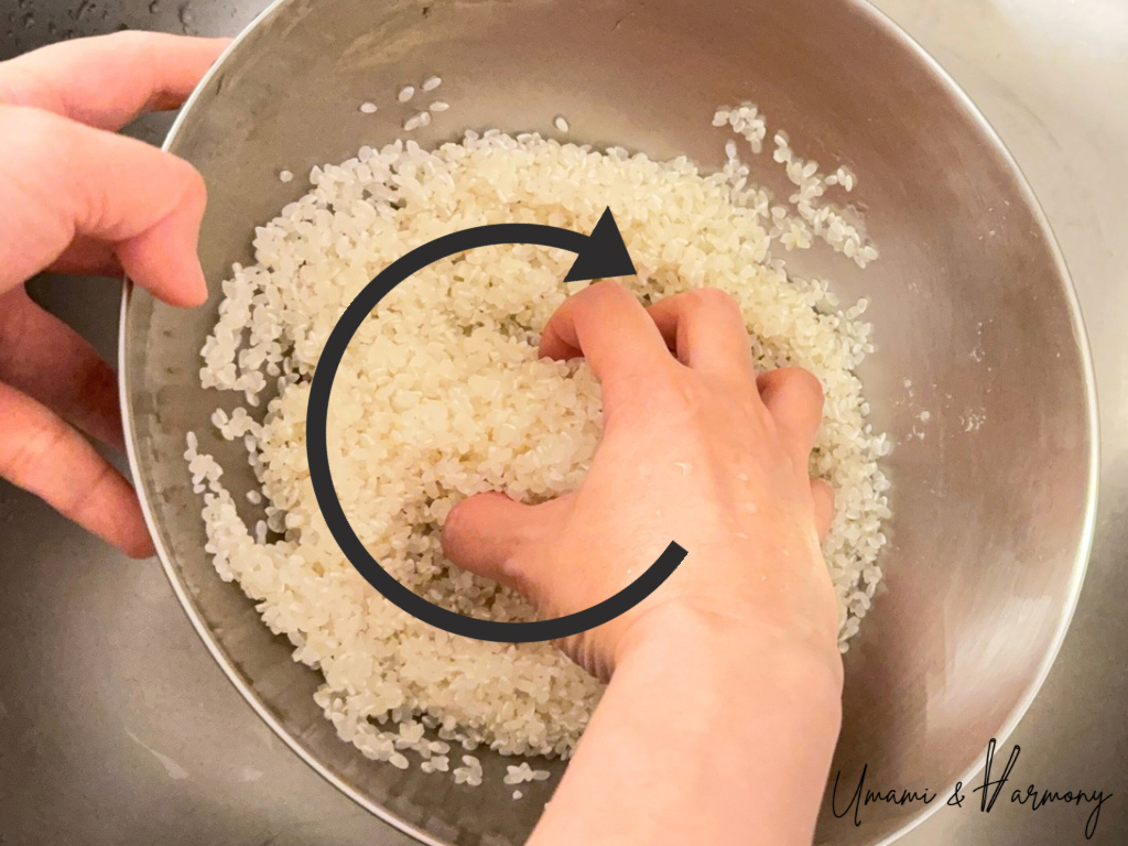 Gently stirring sushi rice with hands during rinsing