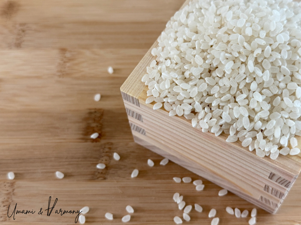 Dried sushi rice in a traditional wooden rice measuring cup