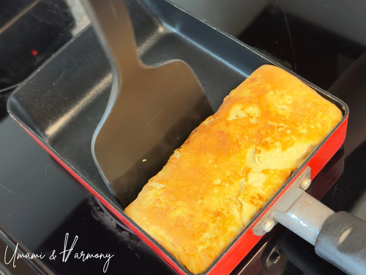 Final tamagoyaki layer rolled back toward you