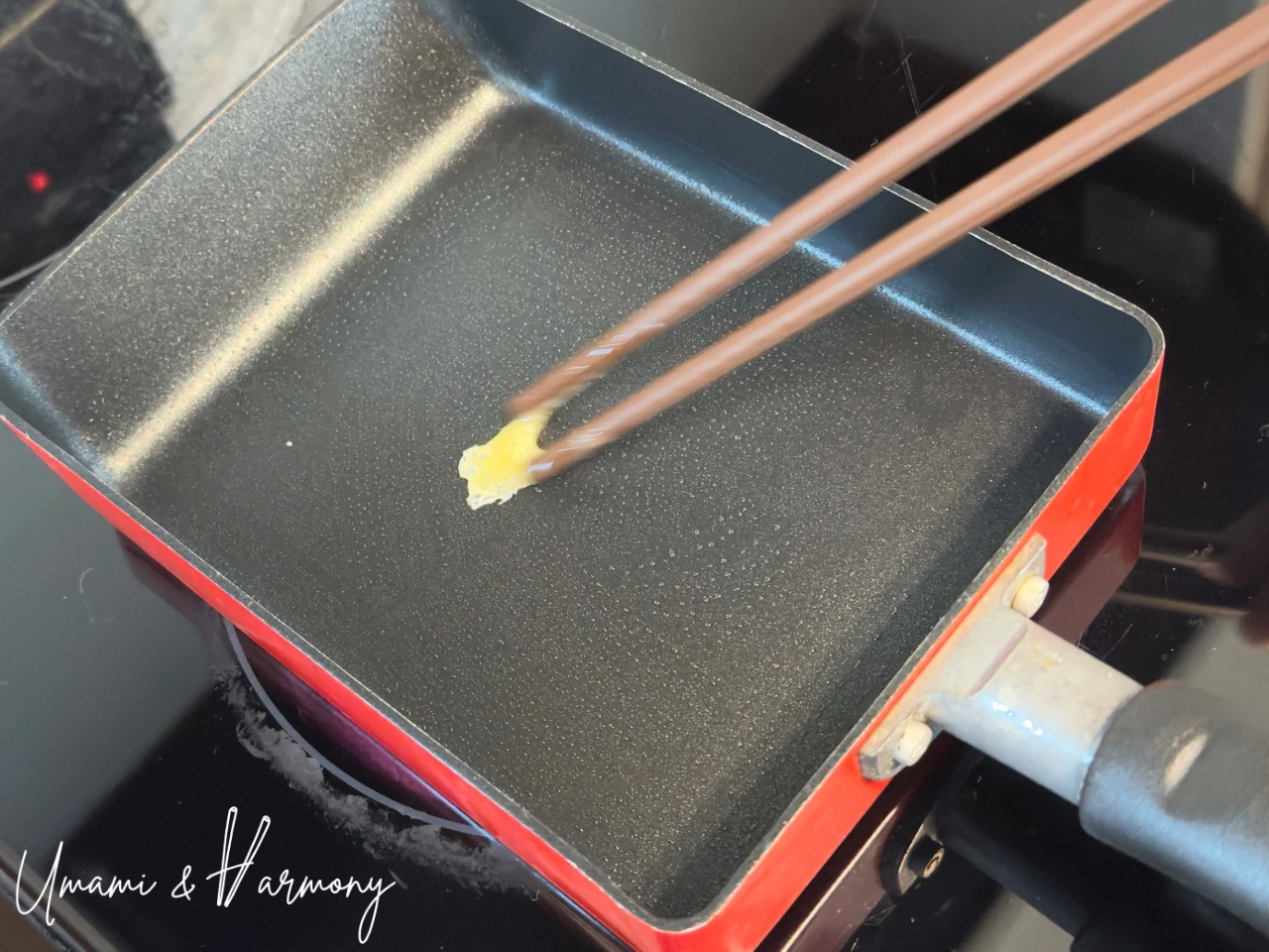 Testing pan heat with a drop of egg mixture