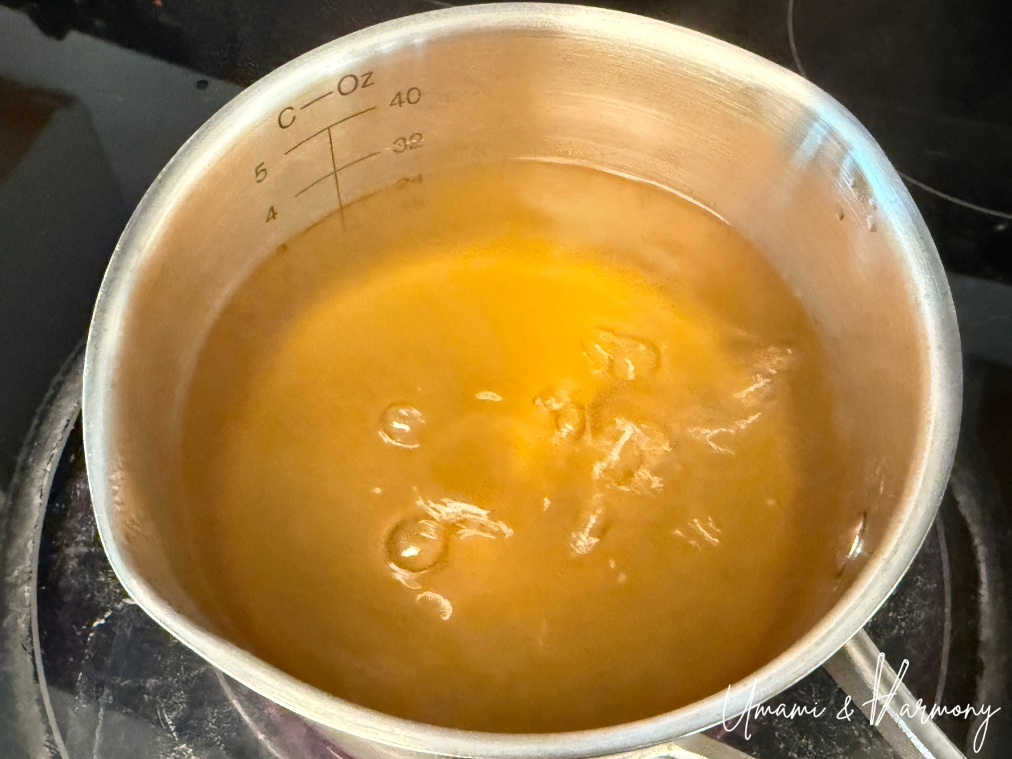 Golden-colored dashi broth boiling in a pot