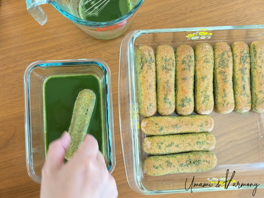 Lining dipped ladyfingers to form the first layer of Matcha Tiramisu