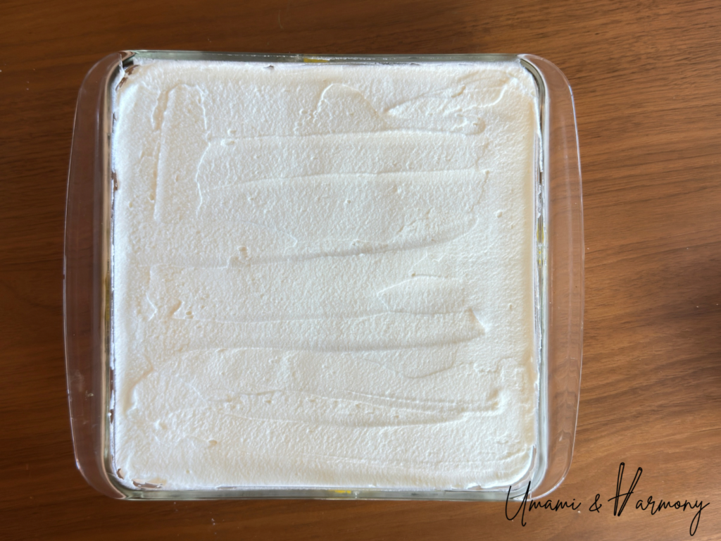 Spreading remaining mascarpone mixture evenly on the second layer