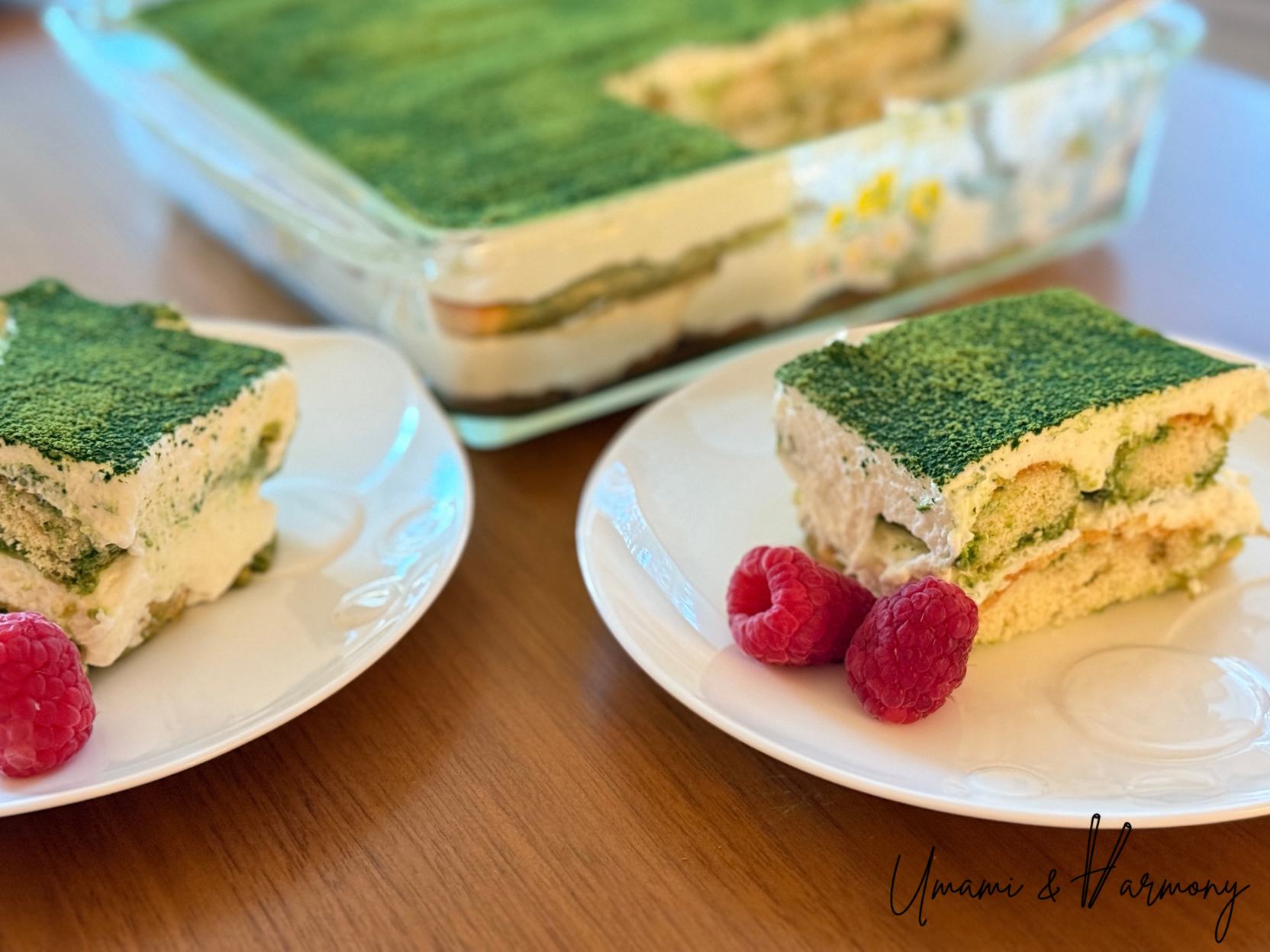 Matcha Tiramisu served on a plate with raspberries