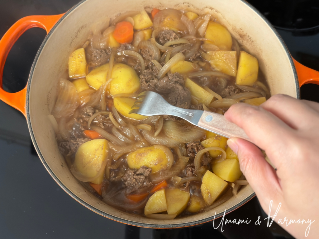 Checking potato doneness by piercing with a fork