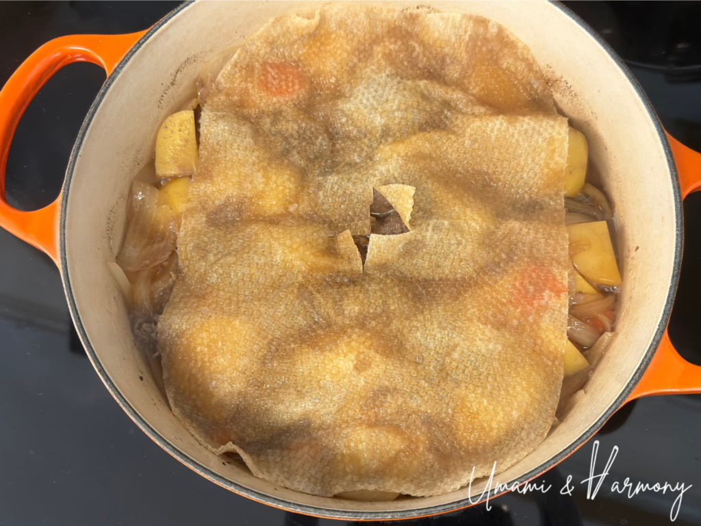 Nikujaga simmering with a drop lid for even cooking