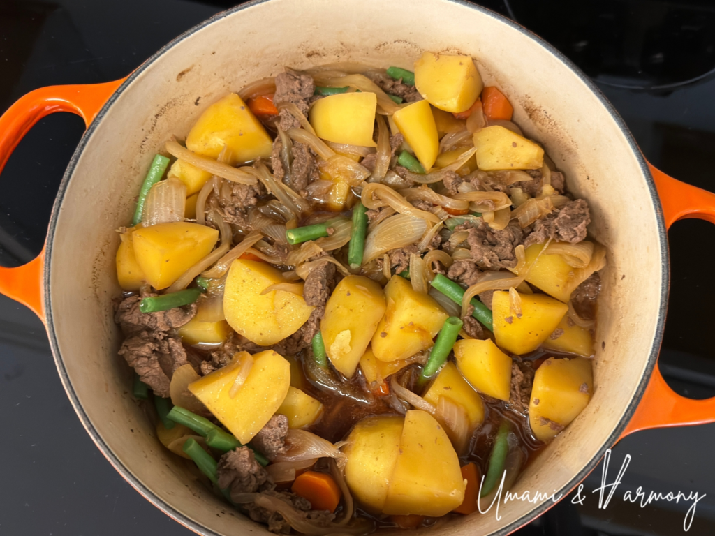 Cooked green beans added and Nikujaga ready to serve