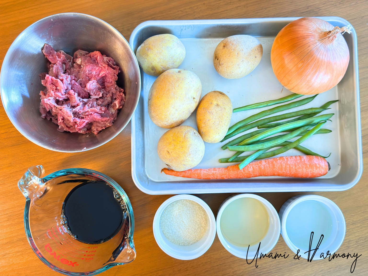 Ingredients for Nikujaga: shaved beef, potatoes, onion, green beans, carrot, soy sauce, sugar, sake, and mirin