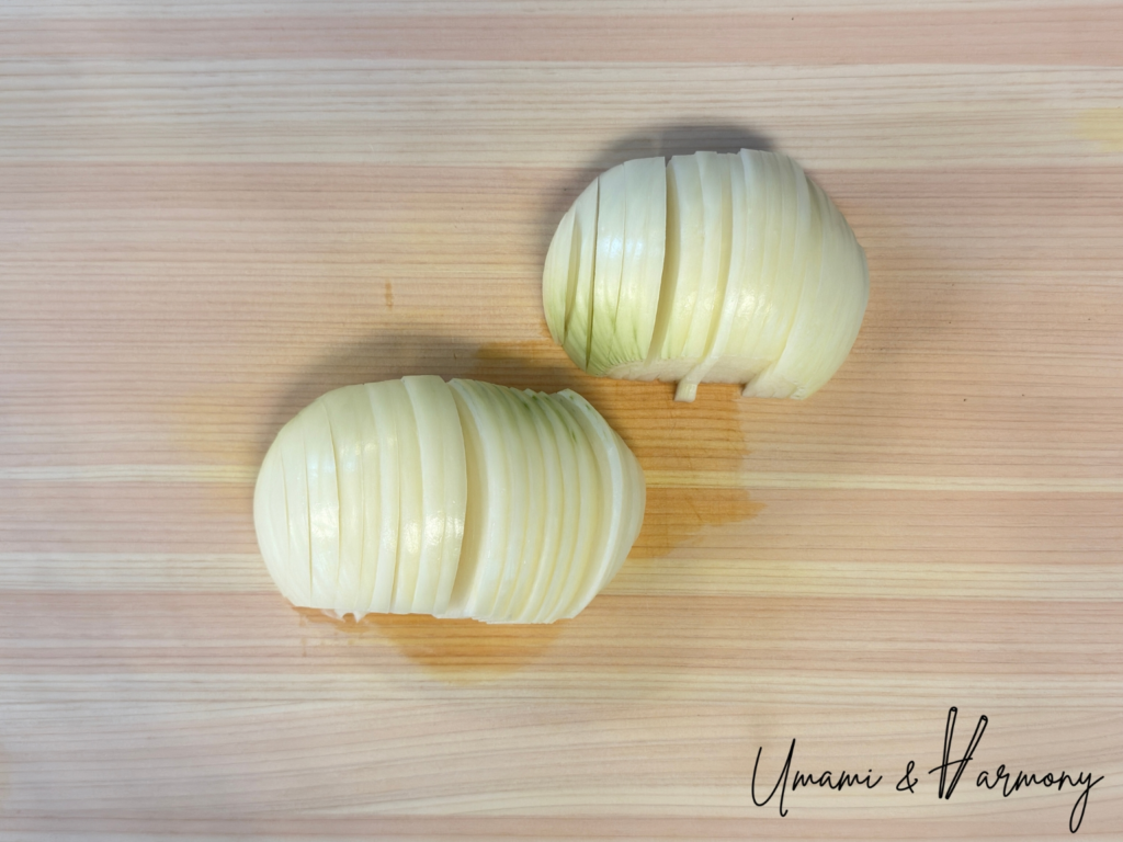 Thinly sliced onion on a cutting board