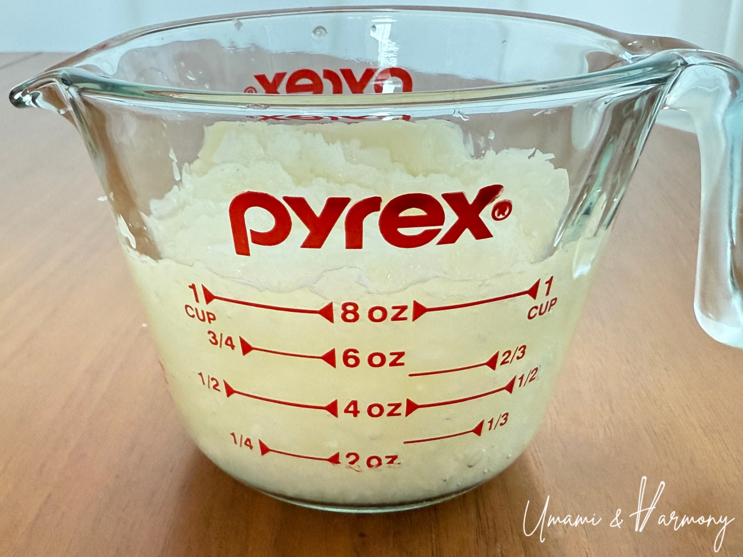 Finely chopped onion and garlic measured to one cup in a measuring cup