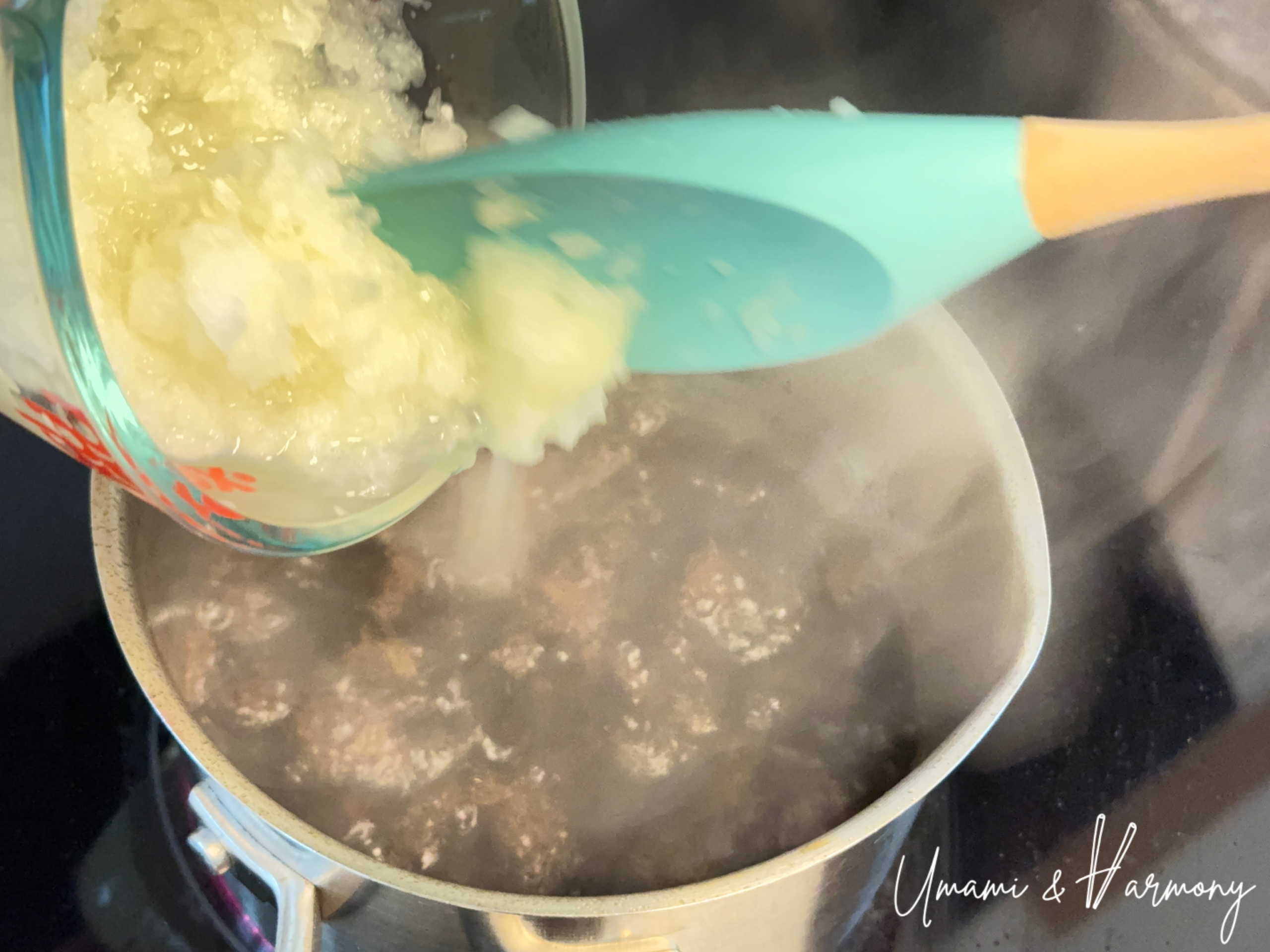 Adding chopped onion to the pot for Japanese onion dressing