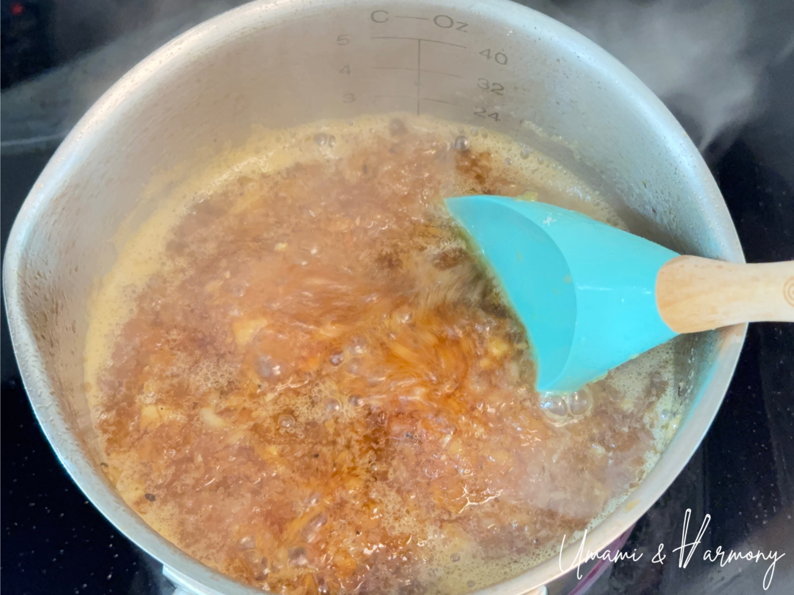 Stirring the onion dressing mixture in a pot with a silicone spatula