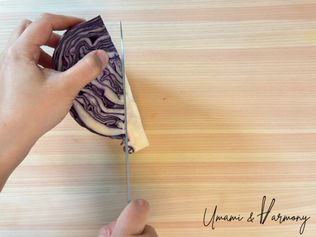 Removing the core from a red cabbage before shredding