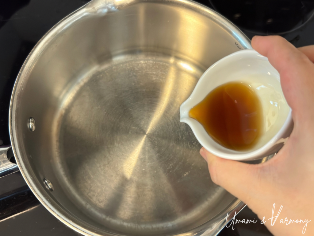 Roasted sesame oil being poured into a pot