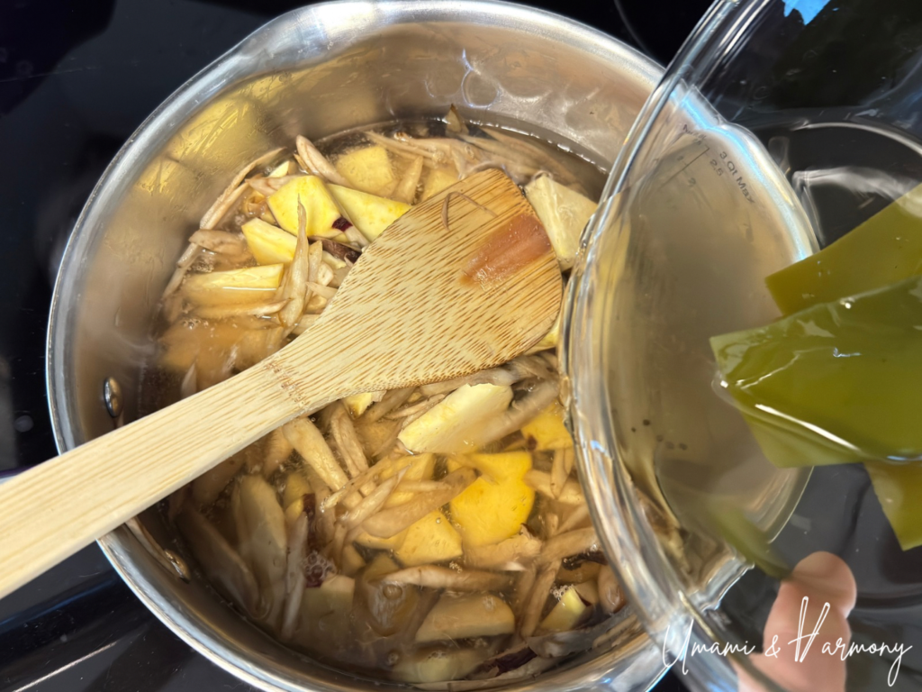 Vegetable dashi soup being added to the pot