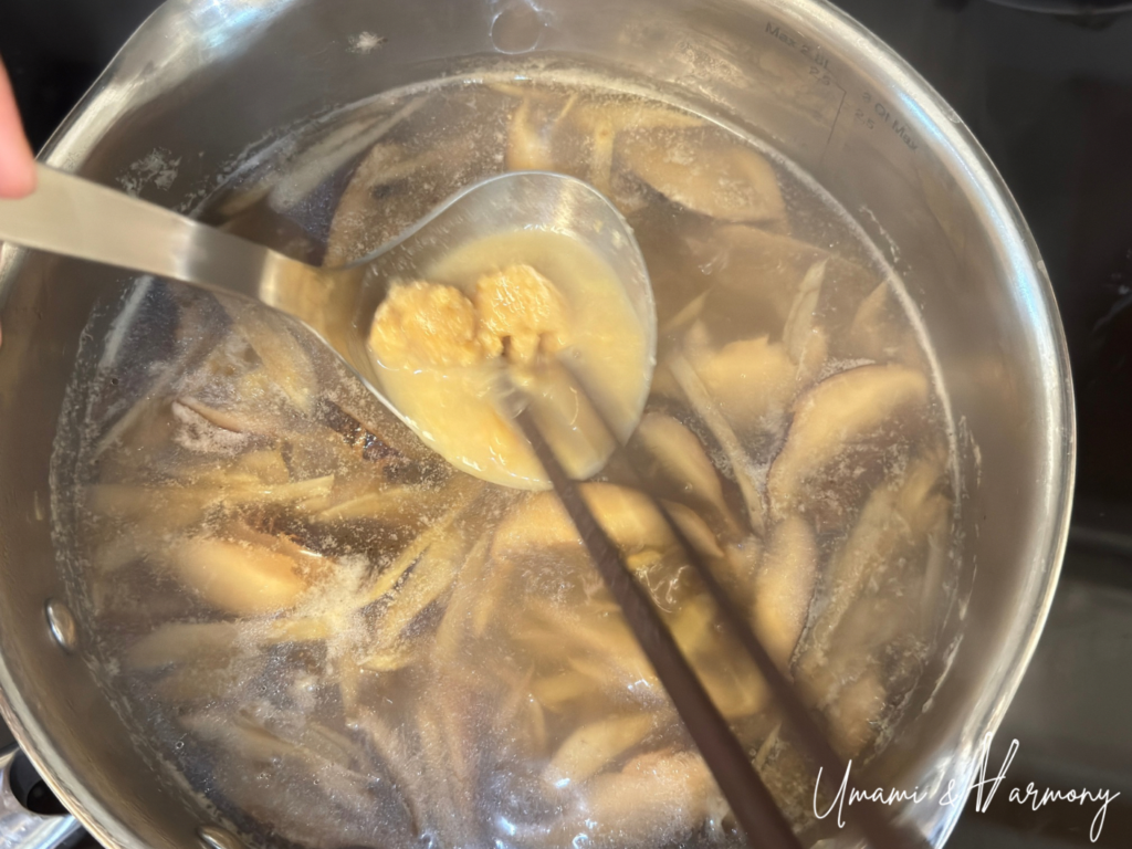 Miso being dissolved into the soup