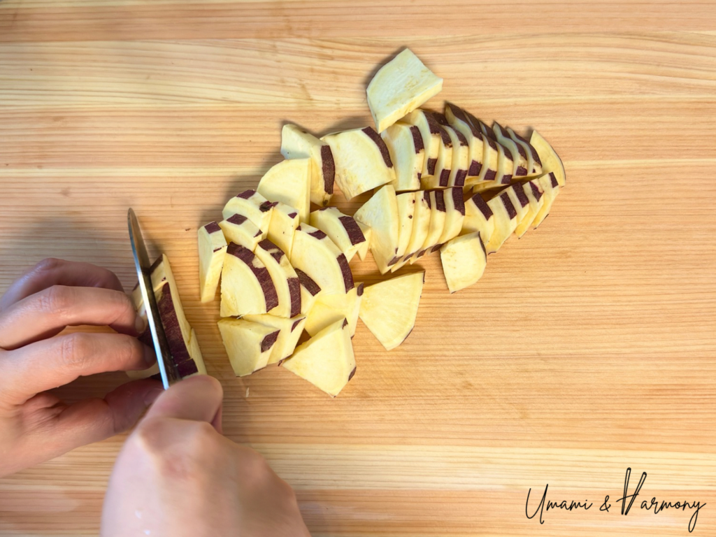 Japanese sweet potato being sliced into half-moon shapes