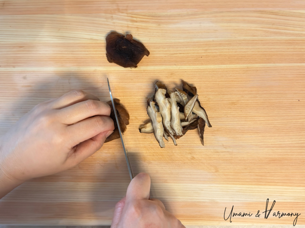 Shiitake mushroom cap being thinly sliced
