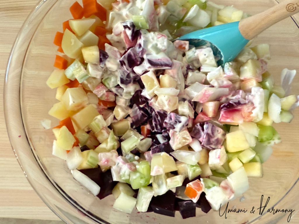 Tossing beet salad gently with dressing