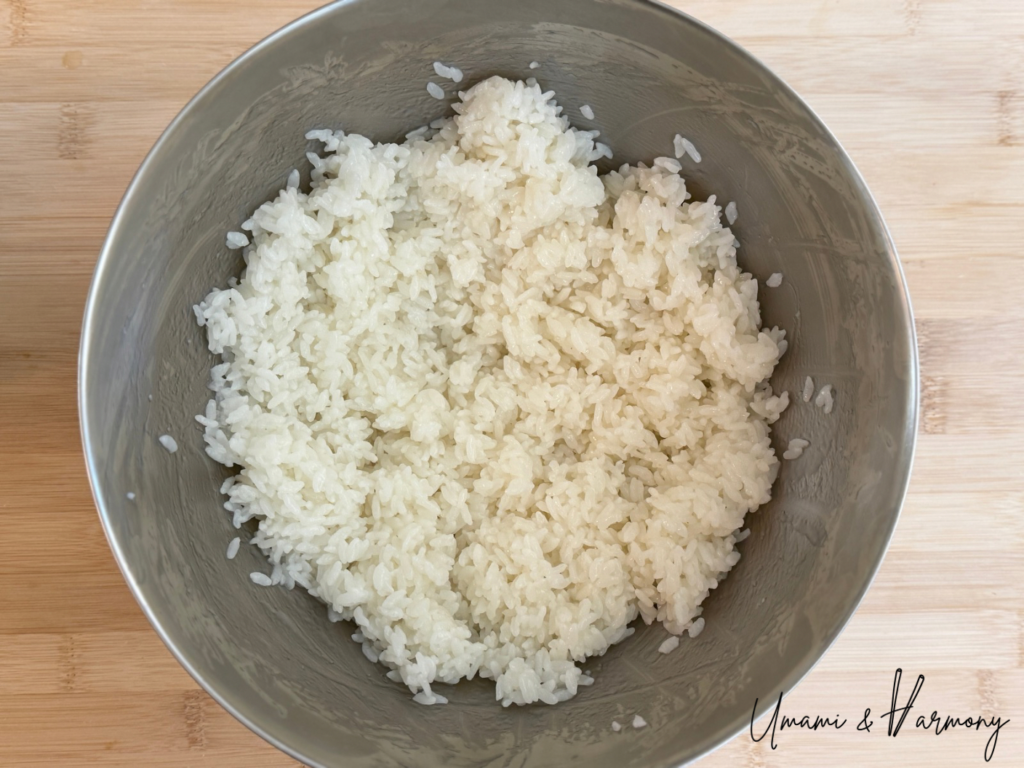 Seasoned sushi rice cooled in a mixing bowl