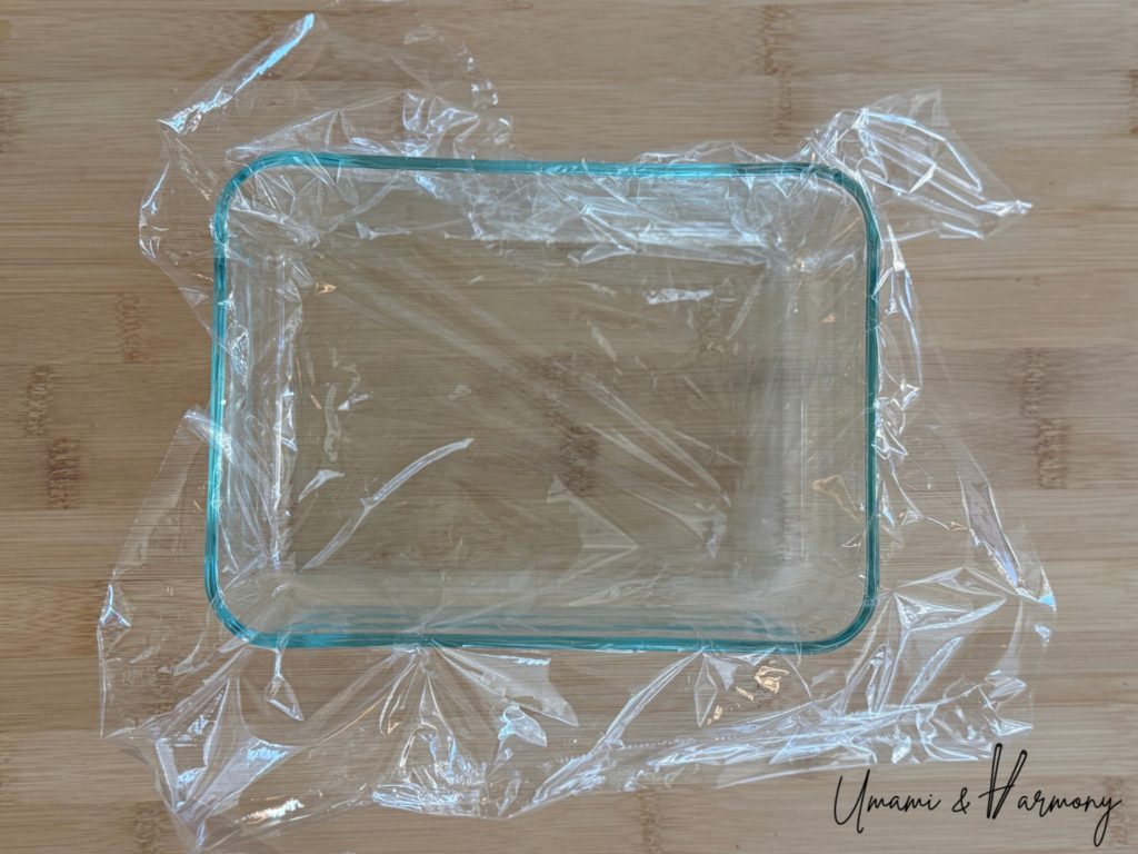 Plastic wrap placed inside a glass sushi mold container
