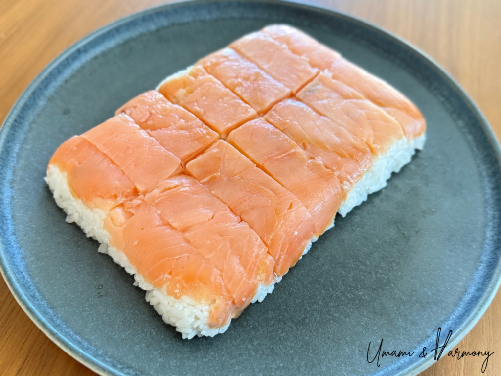 Pressed smoked salmon sushi after cutting