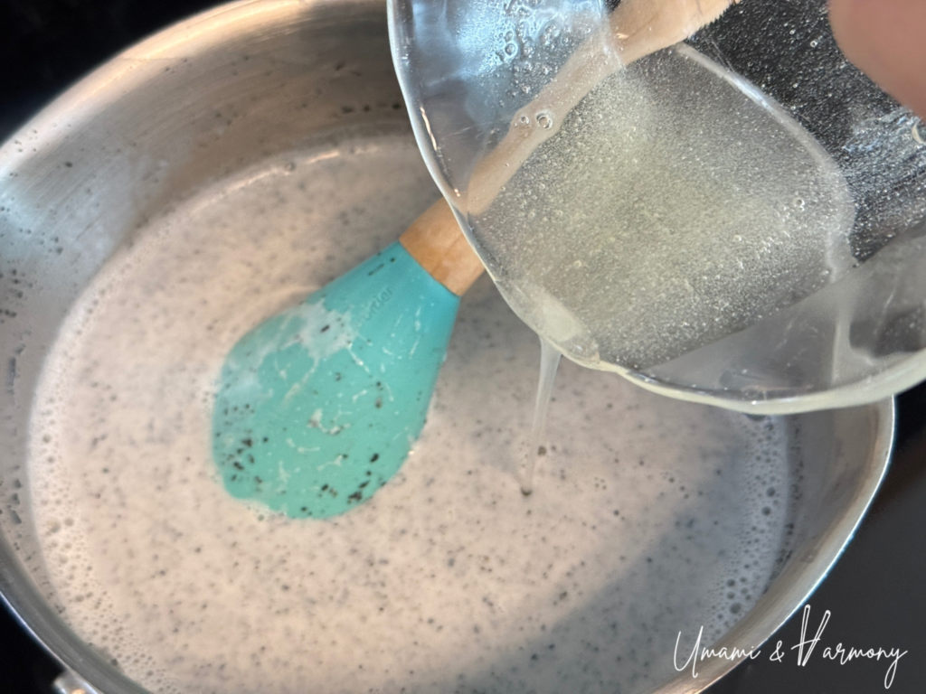 Melted gelatin poured into the black sesame pudding mixture