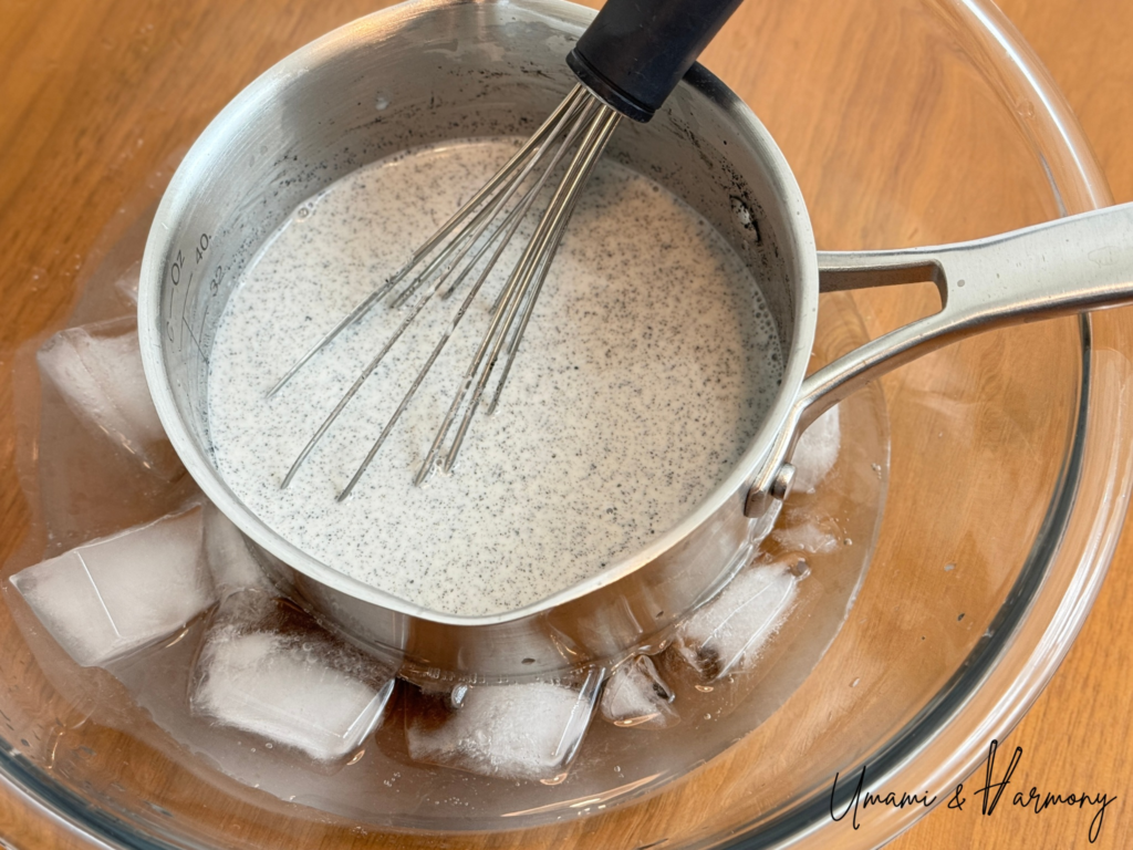 Black sesame pudding mixture cooling over an ice bath