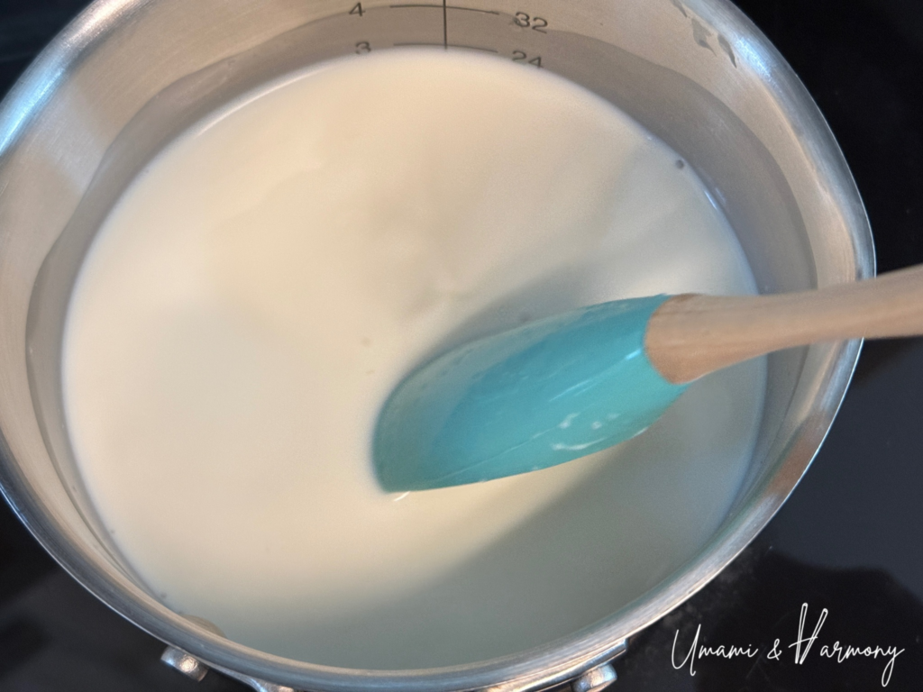 Milk and heavy cream gently heating in a small pot