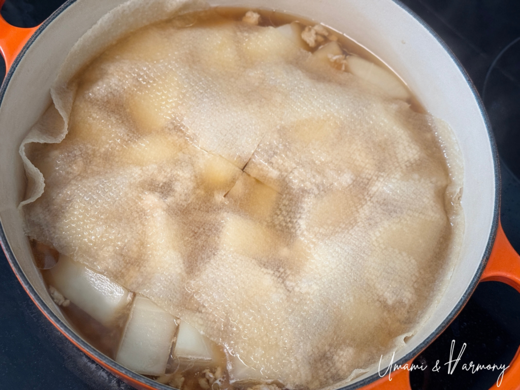 Otoshibuta drop lid placed over daikon while simmering