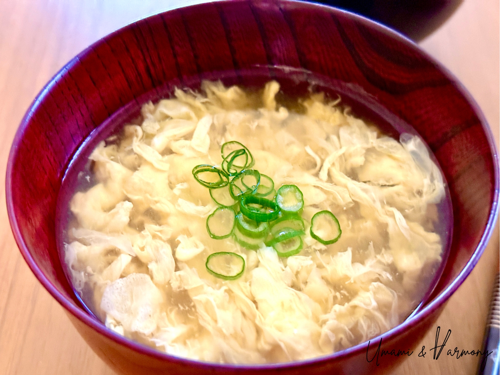 Japanese egg drop soup (kakitama-jiru) served in a bowl with chopped green onion 